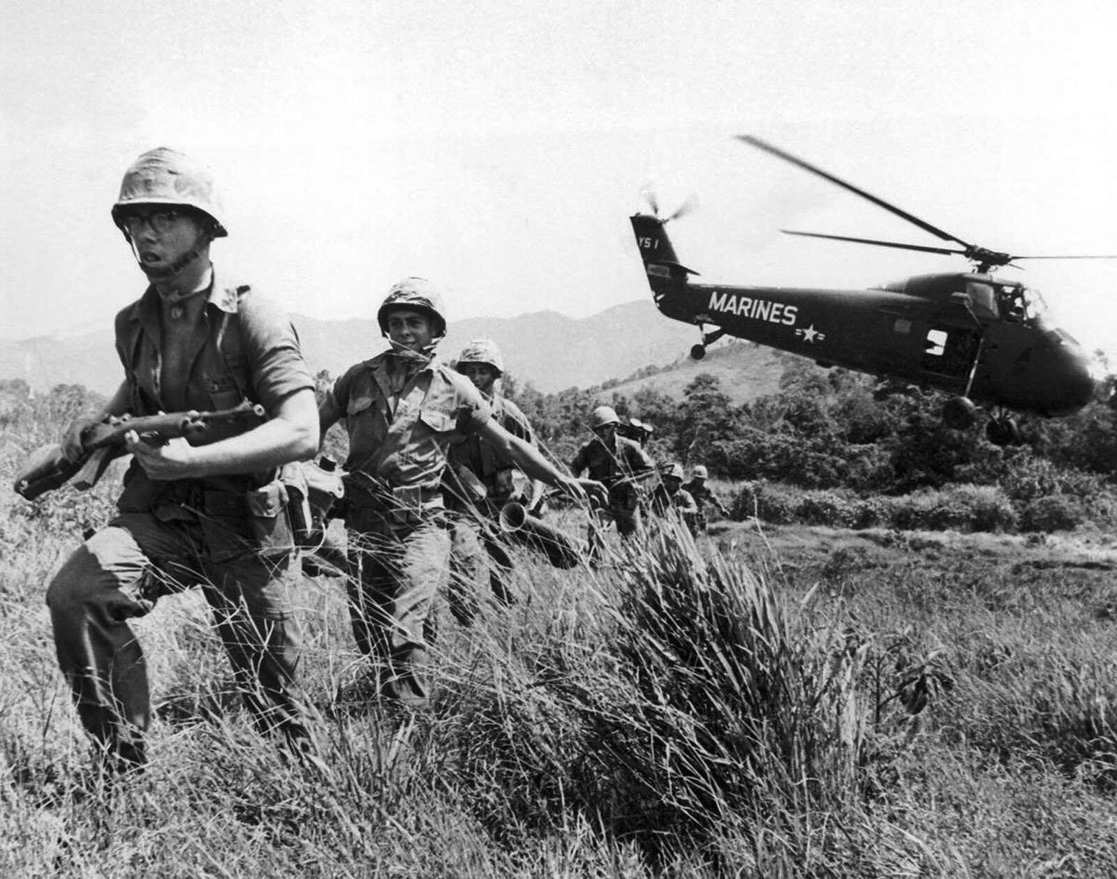 In this April 28, 1965 file photo, U.S. Marine infantry stream into a suspected Viet Cong village near Da Nang in Vietnam during the Vietnamese war. Filmmaker Ken Burns said he hopes his 10-part documentary about the War, which begins Sept. 17, 2017 on PBS, could serve as sort of a vaccine against some problems that took root during the conflict, such as a lack of civil discourse in America