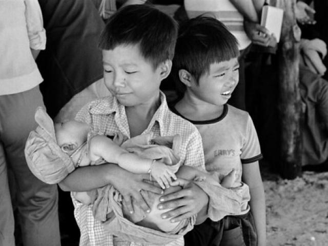 Cambodian children at the Ban Mai Rut refugee camp near Klong Yai, Thailand. There are about 5,200 refugees in this camp which has a permanent wooden structure and several new ones made of Bamboo poles thatched roofs and walls.