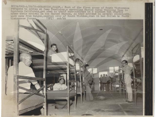 Oceanside, Calif.: Part of the first group of South Vietnamese refugees to arrive at Camp Pendleton, a sprawling Marine Corps Training Base in Southern California, get used to their surroundings in a quonset hut shortly after their arrival in the United States. As they arrived in several planeloads, word came from Saigon, capitol city of South Vietnam, that it had fallen to North Vietnamese forces.