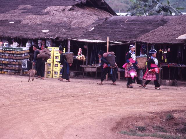 Hmong refugees walking through the Paj Ntaub Market at Vinai Camp during Hmong New Year in 1981. Each center, 9 in total, had their own market from Erica Hagen Vinai Photos Collection.