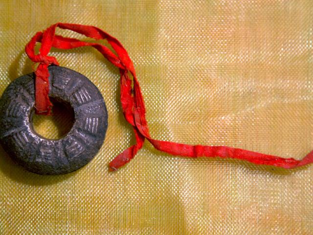 Finger bells (Tswb neeb) often tied with red or white strings is part of the Hmong Shaman tools used to to travel into the spirit world, heal people, and/or fight off evil and lost spirits.