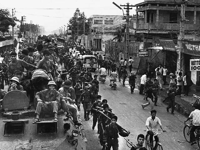 Jubilant communist troops make their way to the center of Saigon as the city fell under their control, April 30, 1975