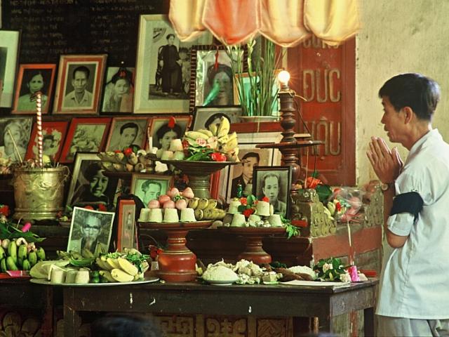 Quan Su, the "Ambassadors' Pagoda" was built in the 1400s for diplomats from the neighboring Buddhist countries of Laos and Siam (now Thailand). It is the most active Buddhist center in Hanoi. Here a man prays for the soul of a relative whose picture joins others on the communal altar.