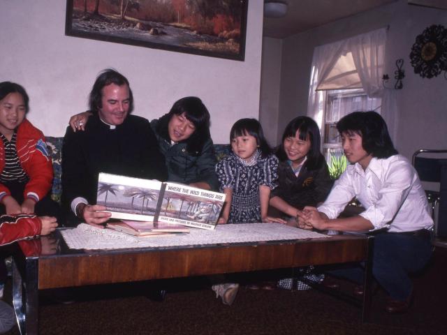 First generation Hmong children in the mid 1980s listening to a Catholic priest read “Where the Wild Things Are.” 