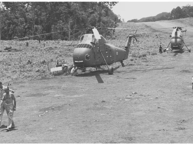 CIA Air Operations in Laos, 1955-1974: Air America UH-34s at Sam Thong, Laos, 1961. The shirtless man at the left is Edgar "Pop" Buell, senior USAID official at Sam Thong. Photo courtesy of E.C. Eckholdt.