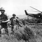 In this April 28, 1965 file photo, U.S. Marine infantry stream into a suspected Viet Cong village near Da Nang in Vietnam during the Vietnamese war. Filmmaker Ken Burns said he hopes his 10-part documentary about the War, which begins Sept. 17, 2017 on PBS, could serve as sort of a vaccine against some problems that took root during the conflict, such as a lack of civil discourse in America