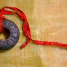 Finger bells (Tswb neeb) often tied with red or white strings is part of the Hmong Shaman tools used to to travel into the spirit world, heal people, and/or fight off evil and lost spirits.