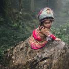This Hmong girl was sitting by herself on a rock five times her size and singing.
