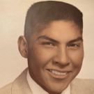 High school senior portrait of Marvin Sam in a suit, approximately age 18.