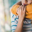 Child embracing parent
