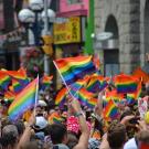 Pride flags wave in crowd