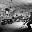 A political re-education class for Generals and senior military officers of the former South Vietnamese Army, a North Vietnamese Communist officer gives them political indoctrination classes as they sit quietly like schoolchildren. Second from left is one time Defense Minister, General Nguyễn Hữu Có. Có was imprisoned for 12 years, decided not to emigrate after being released and lived in Vietnam until his death in 2012.