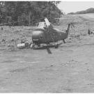 CIA Air Operations in Laos, 1955-1974: Air America UH-34s at Sam Thong, Laos, 1961. The shirtless man at the left is Edgar "Pop" Buell, senior USAID official at Sam Thong. Photo courtesy of E.C. Eckholdt.