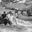 23 Mar 1975, Phu Bon, South Vietnam --- Phu Bon, South Vietnam: Refugees from the Central Highlands run for rescue helicopters to evacuate them to safety. The Communist gunners shot up the convoy of tears heading towards costal havens to the east, splitting it into segments. --- Image by © Bettmann/CORBIS
