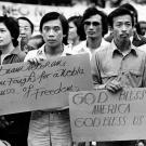 Vietnamese immigrants gather at Houston City Hall with signs for the ceremony of the sixth anniversary of the fall of South Vietnam, 1981.